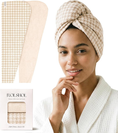 ROLSHOL hair towel wrap shown flat in beige houndstooth pattern alongside a woman wearing one twisted on her head. Below, the product's white retail box reads 'ROLSHOL Premium 100% Cotton Hair Towels' and 'Soft Cotton Shower Set'.