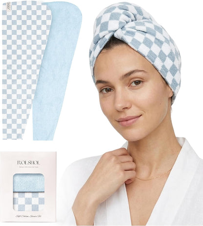 Blue and white checkered cotton hair towel wrap shown flat and worn as a turban on a woman in a white robe, alongside product packaging labeled ROLSHOL with 'Soft Cotton Shower Set' text.