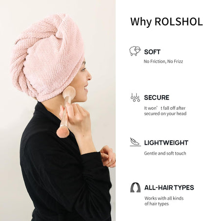 Promotional graphic for ROLSHOL hair towel. A woman in a black turtleneck applies makeup while wearing a light pink twisted hair towel turban. Text lists four benefits: Soft (No Friction, No Frizz), Secure, Lightweight, and All-Hair Types.