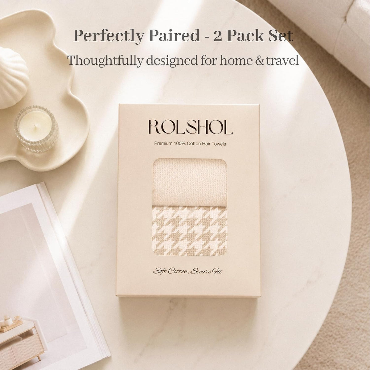 ROLSHOL branded gift box containing 2 cotton hair towels in apricot/cream tones -- one solid textured and one houndstooth patterned. Box reads 'Premium 100% Cotton Hair Towels' and 'Soft Cotton, Secure Fit', displayed on a marble table.
