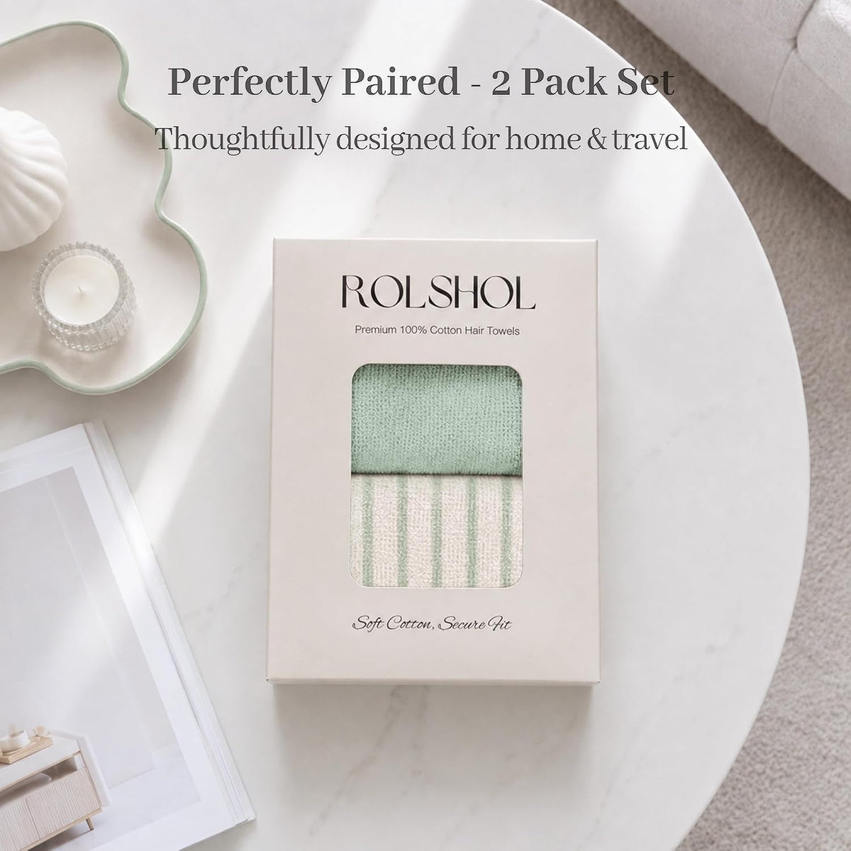 ROLSHOL Premium 100% Cotton Hair Towels in a cream gift box with window, showing a sage green solid towel and a green-striped cream towel. Text reads 'Soft Cotton, Secure Fit.' Styled on a marble table.