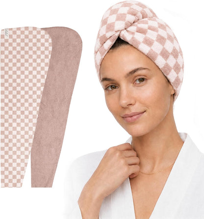 Two hair towel wraps in a dusty rose checkered pattern shown flat on the left, alongside a woman wearing one wrapped on her head as a turban, secured with a twisted knot at the top. She wears a white robe.