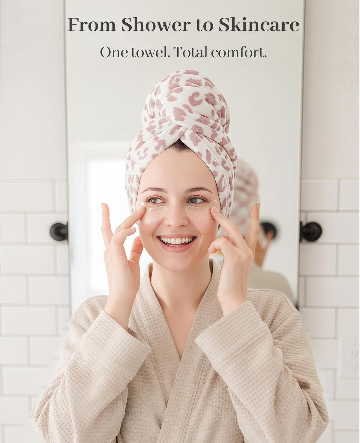Woman in a waffle-weave cream robe applying skincare while wearing a white and pink leopard-print hair towel wrap twisted on her head. Text reads 'From Shower to Skincare - One towel. Total comfort.'