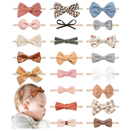 Collection of 21 baby bow headbands on elastic nylon bands in various fabrics and patterns including floral, leopard print, gingham, velvet, lace, and solid colors. Bottom left shows a sleeping infant wearing a rust-colored bow headband.