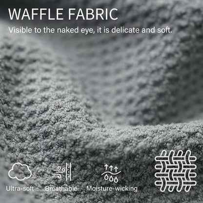 Close-up of grey waffle-textured fabric with text 'WAFFLE FABRIC - Visible to the naked eye, it is delicate and soft.' Four icons below label the fabric as Ultra-soft, Breathable, Moisture-wicking, and show a weave pattern.