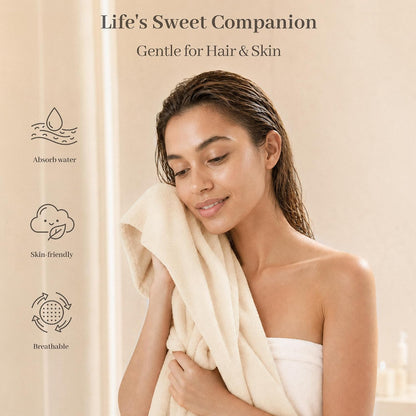 Promotional banner for a soft cream-colored cotton hair towel. A woman with wet hair holds the towel against her face and shoulder. Text reads 'Life's Sweet Companion, Gentle for Hair & Skin' with icons for Absorb Water, Skin-friendly, and Breathable.
