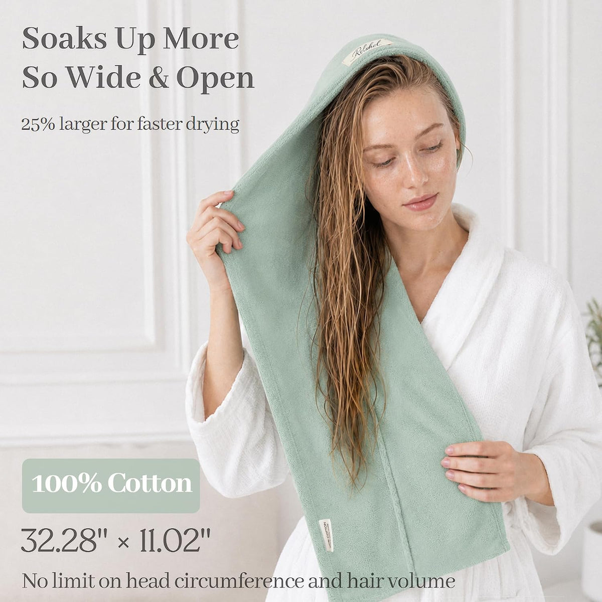Promotional image of a light green cotton hair towel wrap draped over a woman's wet hair. Text states 'Soaks Up More So Wide & Open,' '25% larger for faster drying,' '100% Cotton,' '32.28" x 11.02",' and 'No limit on head circumference and hair volume.'