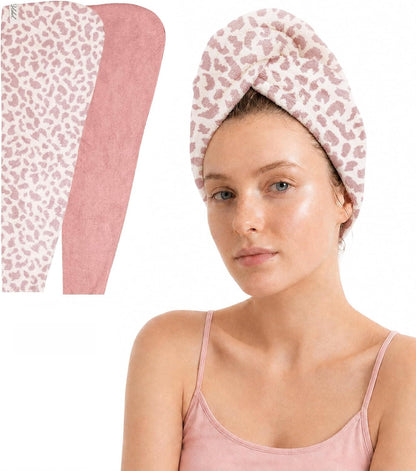 Two hair towel wraps shown flat on left: one white with pink leopard print, one solid dusty pink. On right, a woman wears the leopard print wrap twisted on her head. Both have soft, textured fabric.