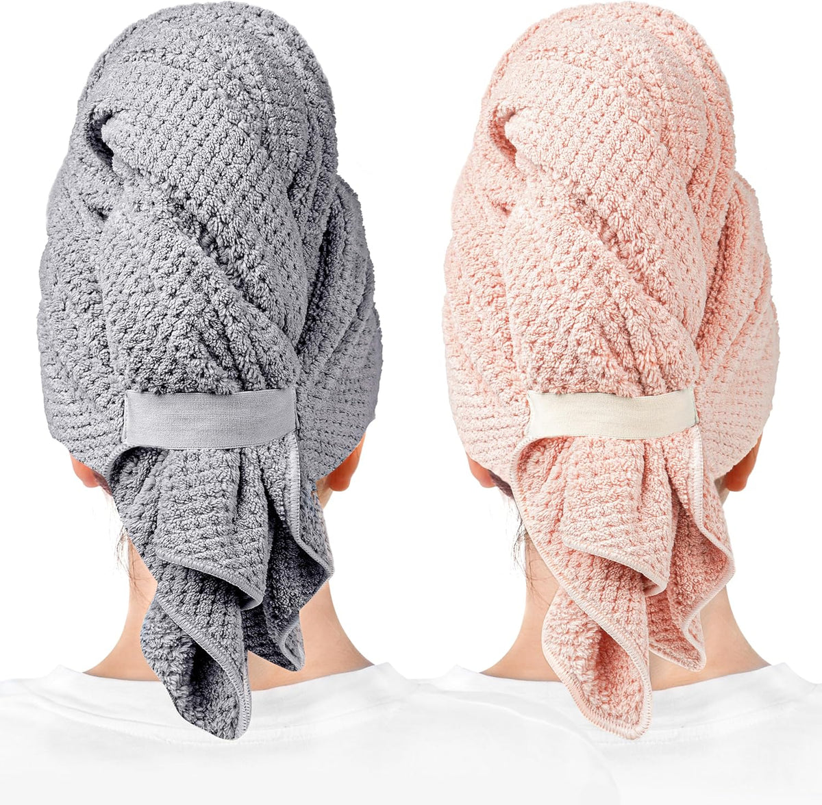 Two hair towel wraps worn on heads, shown from behind. Left wrap is gray with a textured waffle pattern and elastic band closure; right is light pink with the same design. Both have loose fabric draping at the nape.